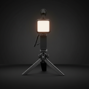 Assembled vlogging kit with glowing LED light on dark background